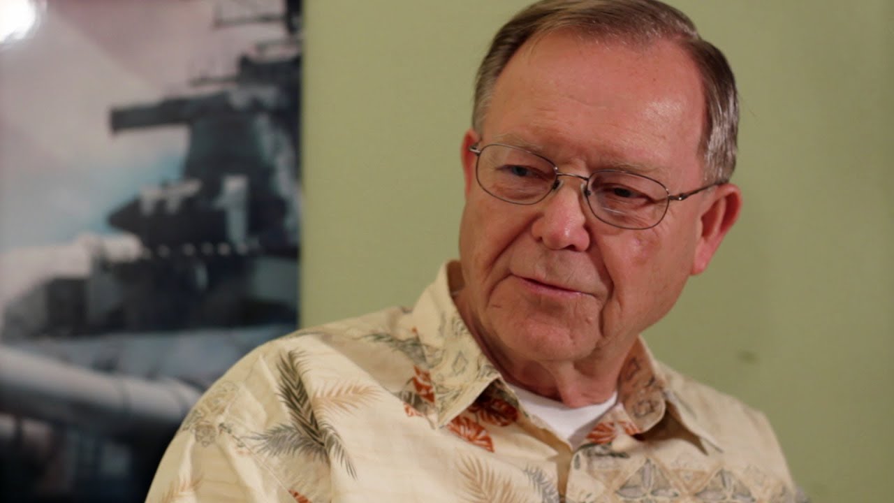 A man in glasses and a floral shirt.