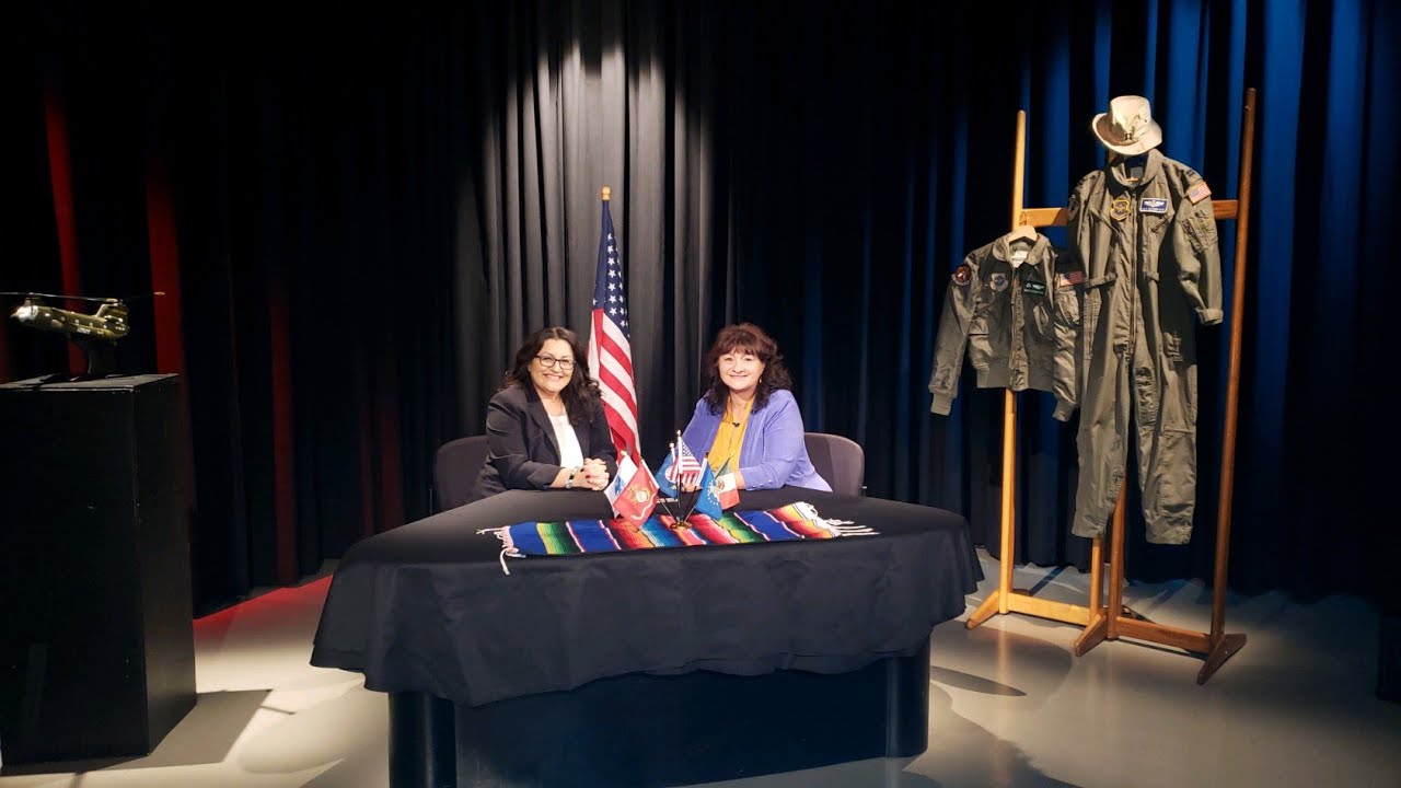 Two women sitting at a table with american flags.