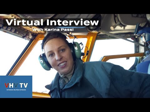 A woman in an airplane wearing headphones and smiling.